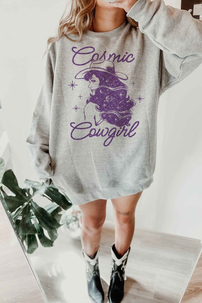 An oversized sweatshirt made from premium cotton featuring a "Cosmic Cowgirl" design. The design likely depicts a cowgirl character with celestial or space-themed elements.