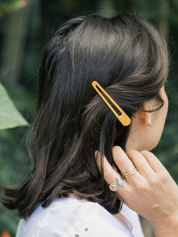 Two bright yellow triangle hair clips made of metal. Each clip is approximately 3.2 inches long.