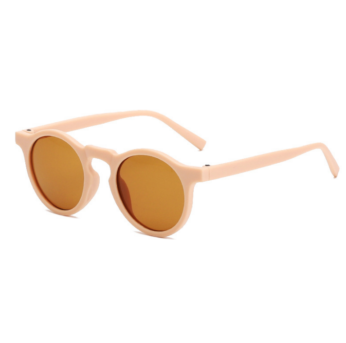 Soft pink  round sunglasses with a retro style.   The sunglasses have shatterproof lenses and are made from BPA-free materials.